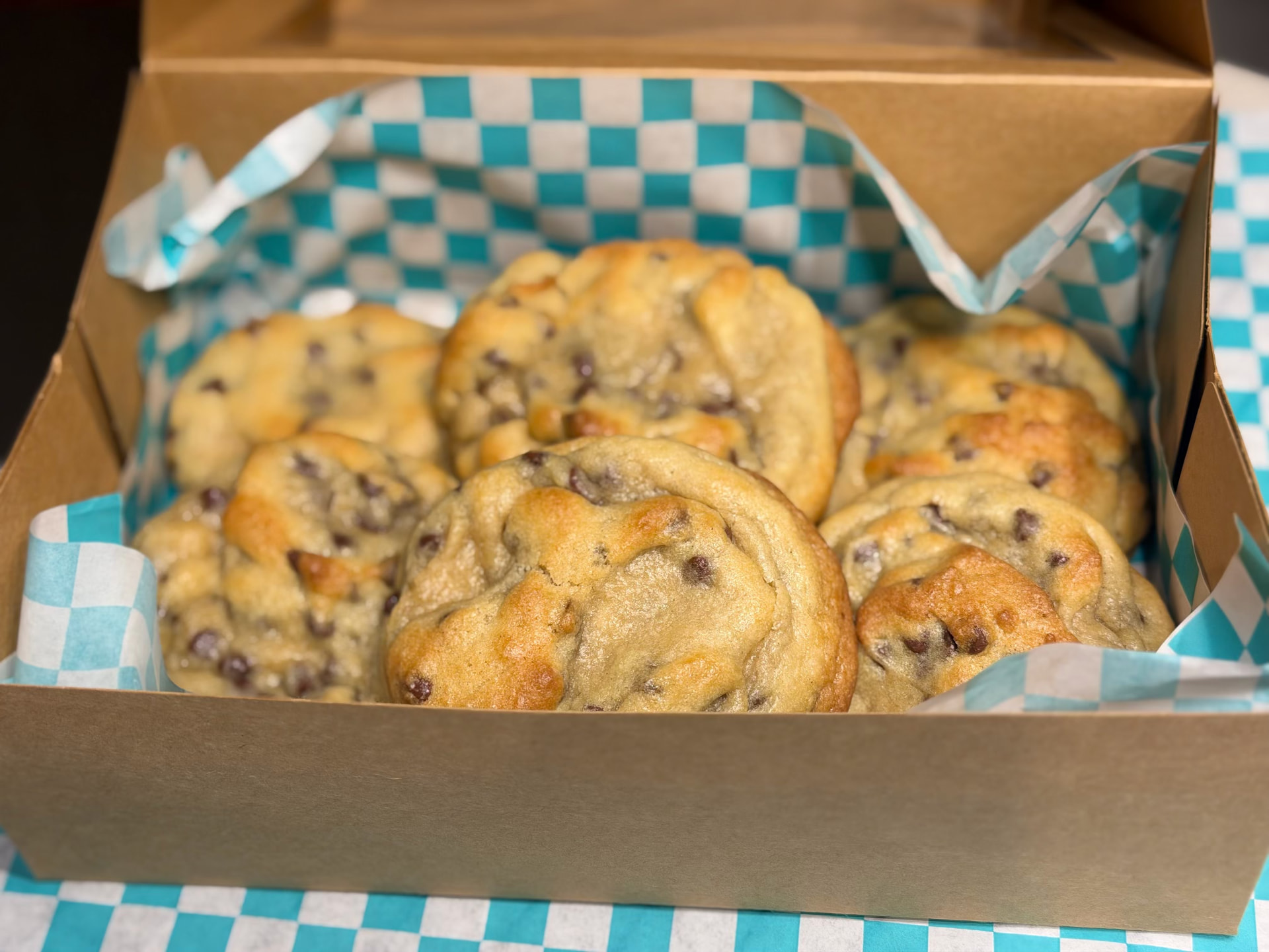 A dozen hand-packed cookies in a kraft bakery box